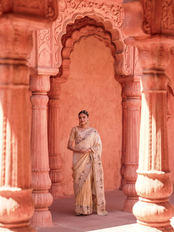 Warm ivory wedding saree with paisley botanical and feather-like border