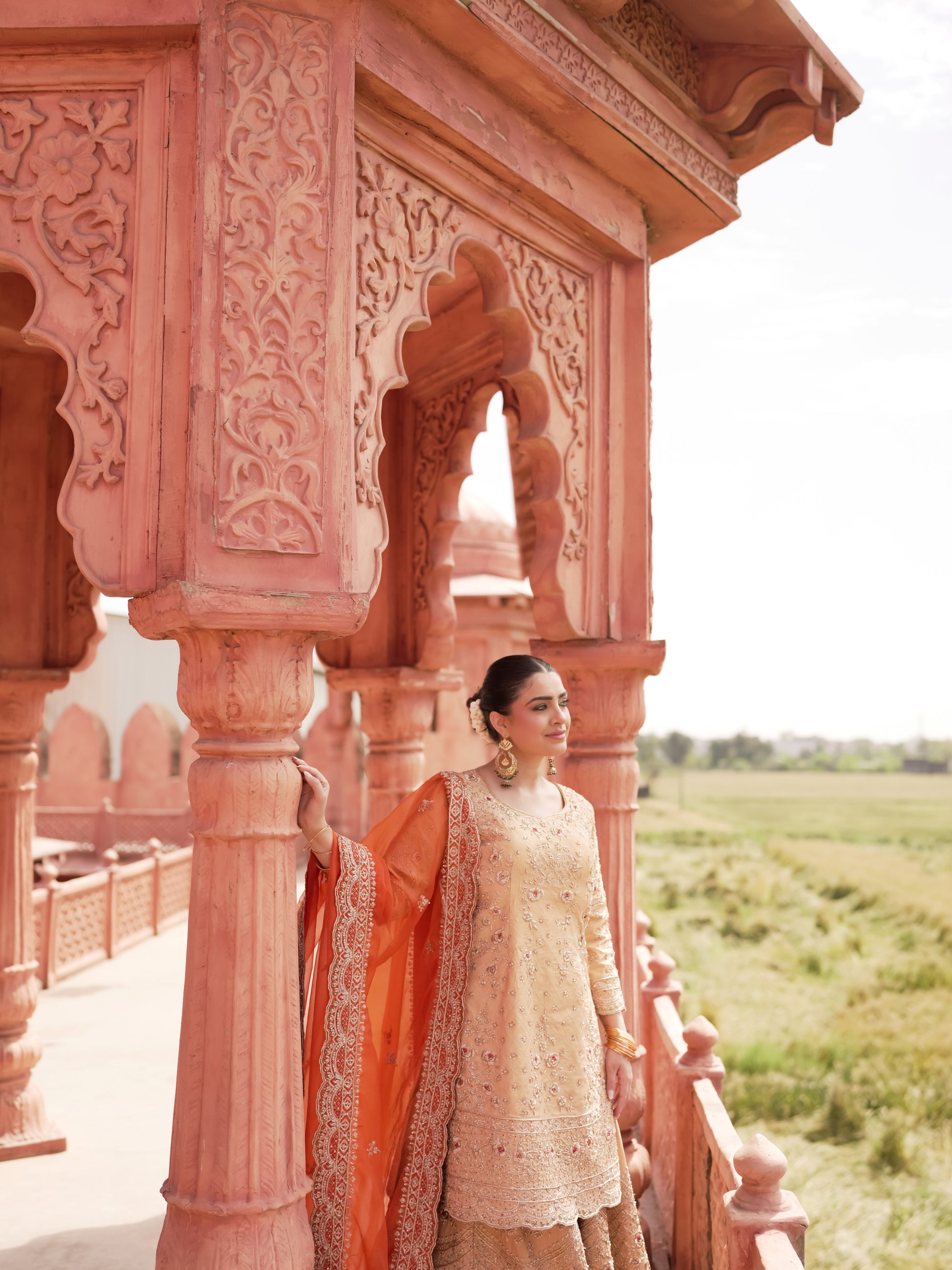 Peach gold festive sharara set with coral red contrast dupatta