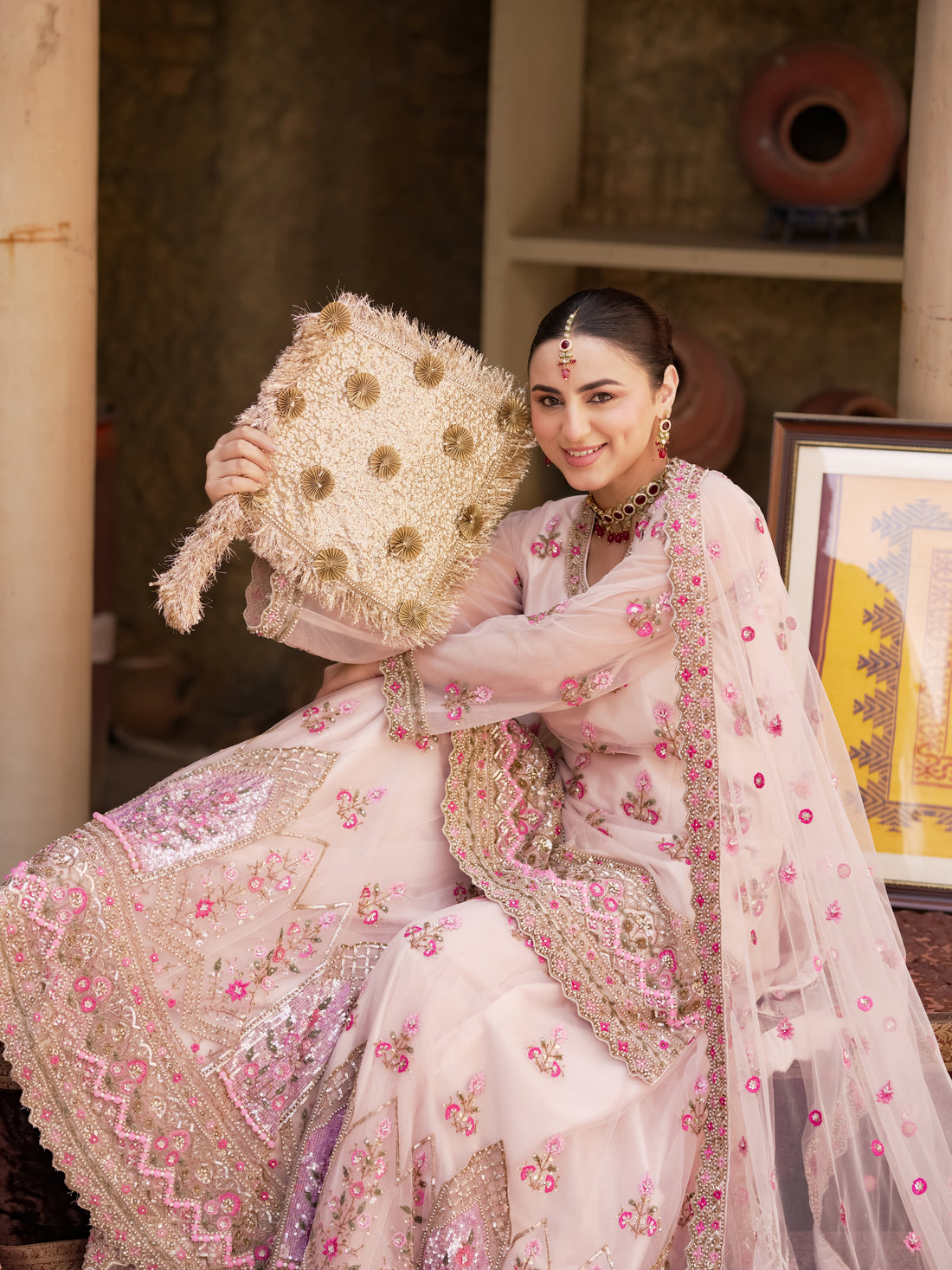 Blush pink floral lehenga with fuchsia accents and net dupatta