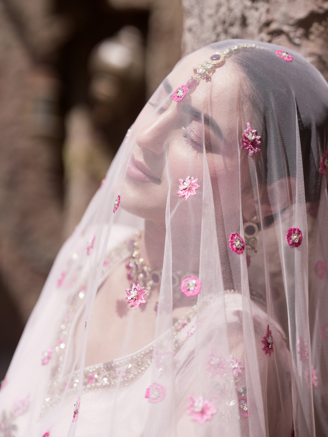 Blush pink floral lehenga with fuchsia accents and net dupatta