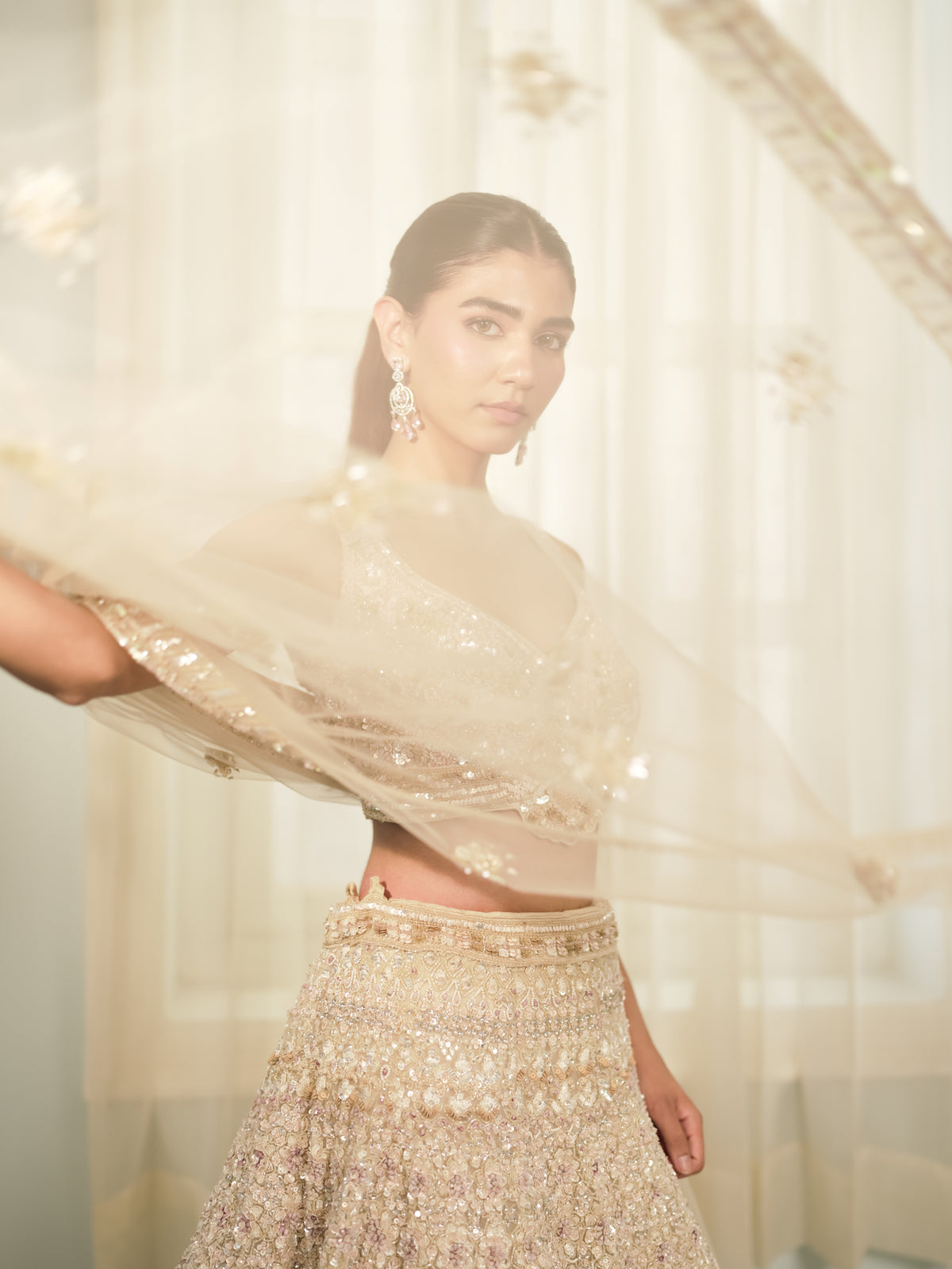 Full-flare ivory reception lehenga with sleeveless V-neck blouse